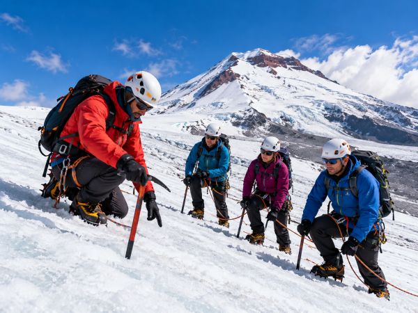 Mountaineers practicing glacier climbing and safety techniques on Cotopaxi Volcano in Cotopaxi National Park, Ecuador. Led by an experienced mountain guide, climbers learn crampon use, ice axe techniques, rope travel, and self-arrest skills on the snow-covered slopes of Cotopaxi, surrounded by breathtaking glacier landscapes in the Ecuadorian Andes.