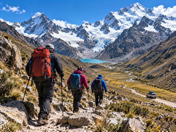 Mountaineers descending Ishinca Valley in Peru's Cordillera Blanca, trekking through spectacular Andean landscapes and snow-capped peaks before returning to Huaraz after their climbing expedition.