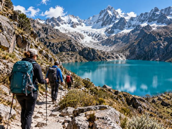 Hikers trekking toward Churup Lake (Laguna Churup) near Huaraz, Peru, during a high-altitude acclimatization adventure in the Cordillera Blanca. Surrounded by spectacular snow-capped Andean peaks, rugged mountain trails, and crystal-clear turquoise glacial waters, this scenic hike offers breathtaking landscapes and an unforgettable trekking experience in Huascarán National Park, preparing climbers for upcoming mountaineering expeditions in the Peruvian Andes.